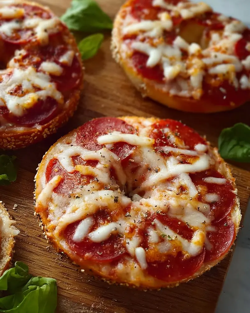 Easy Mini Bagel Pizzas 3 A close-up of mini bagel pizzas baking in the oven, with cheese bubbling.
